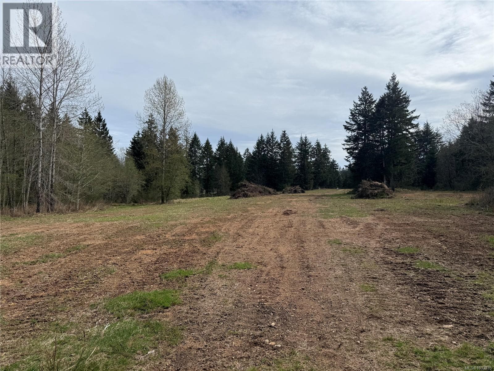 vacant land at 7481 Island Hwy — $1,395,000